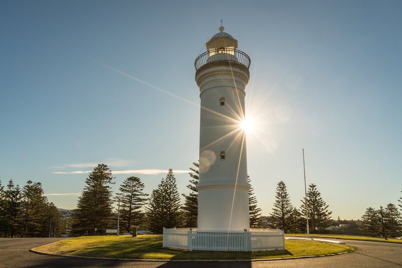 Kiama lighthouse with a starburst of sunlight behind it