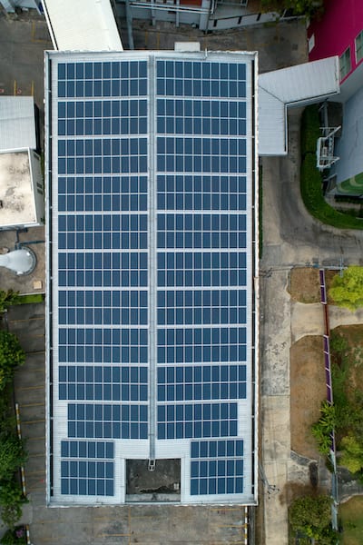 Aerial view of solar panels on top of building.